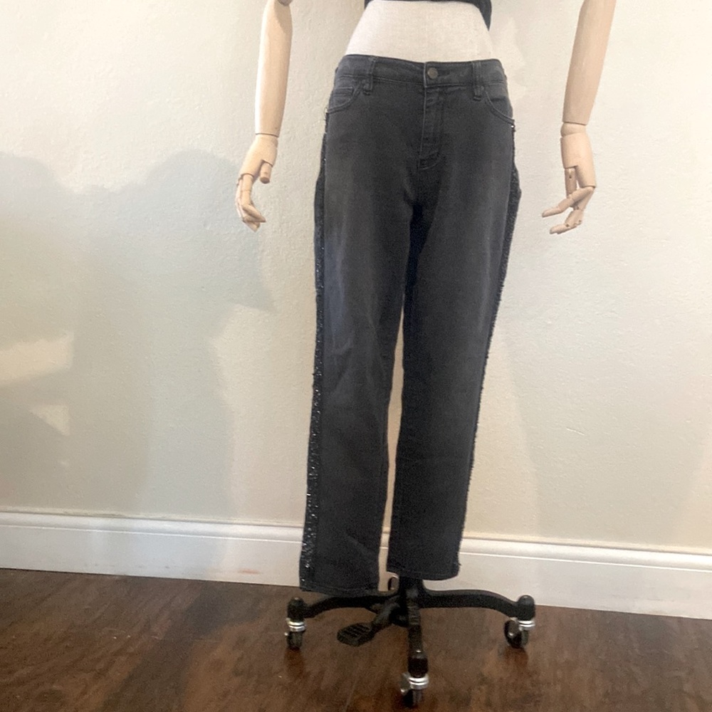Distressed black denim tapered jeans with black sequin embellishment down legs.